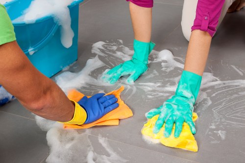 Local cleaner tidying a modern flat kitchen in W3