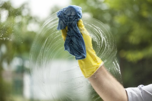 Professional cleaner refreshing a kitchen and bathroom during an Airbnb turnover in W3